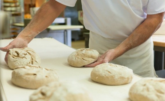 baker with fresh bread dough